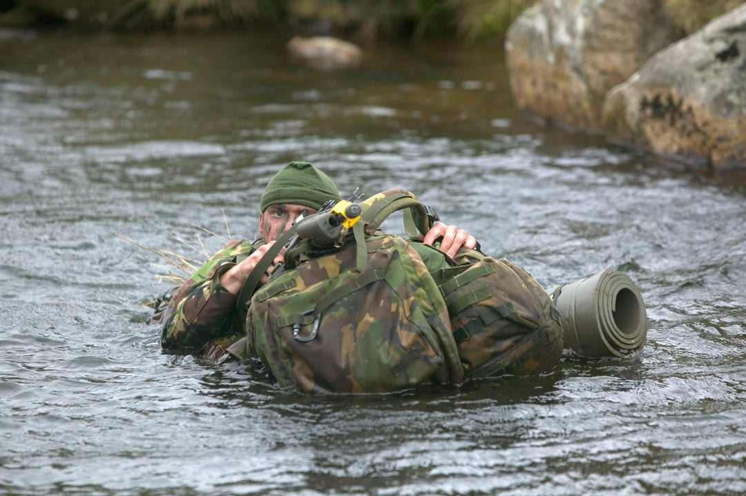 Soldier carrying a full Bergen rucksack during a commando conditioning course