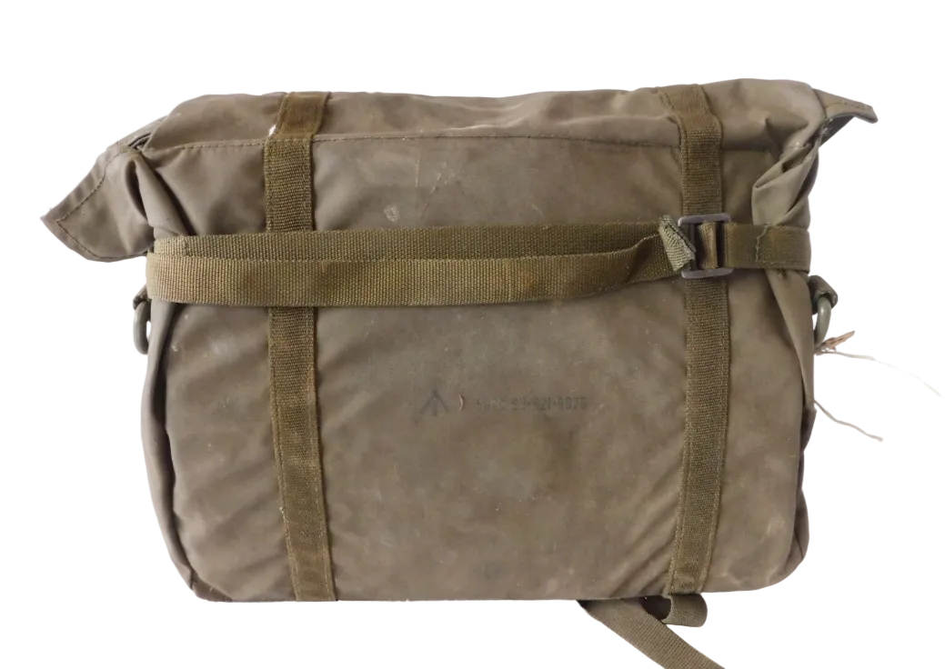 An olive green military-style canvas roll-top bag with a roll-top flap, two vertical webbing straps, and a horizontal buckle strap across the front, photographed against a plain white background.