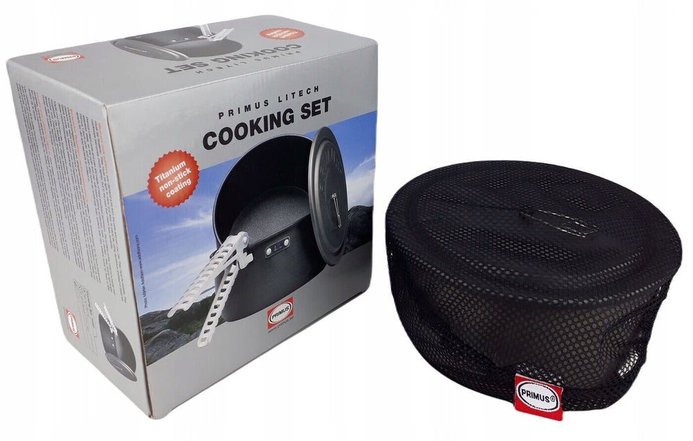 Cooking pot inside black mesh bag next to the original box