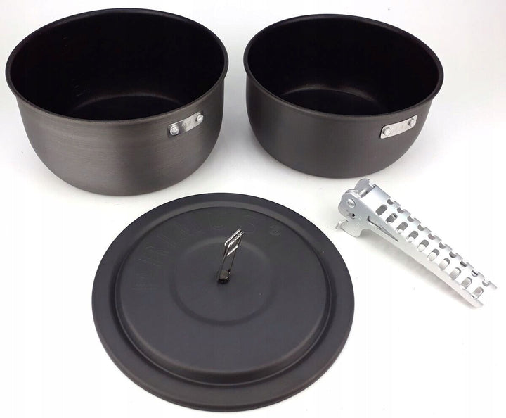 two black cooking pots with detachable silver handle and matching lid 