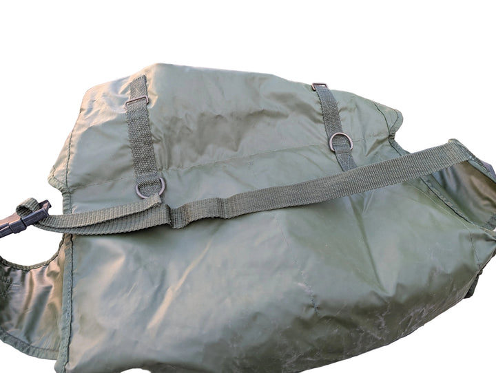 Green military-style duffel bag on a vehicle