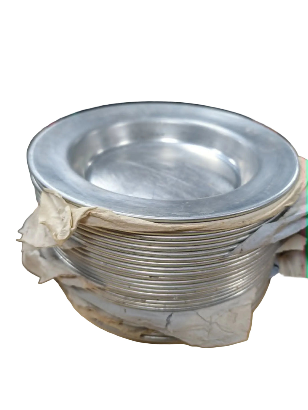 Stack of metal bowls on a wooden surface with a person in the background.