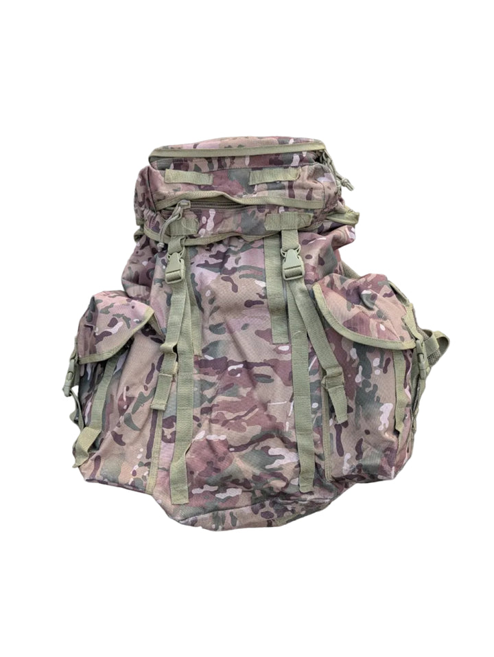 Camouflage backpack on a gray pavement