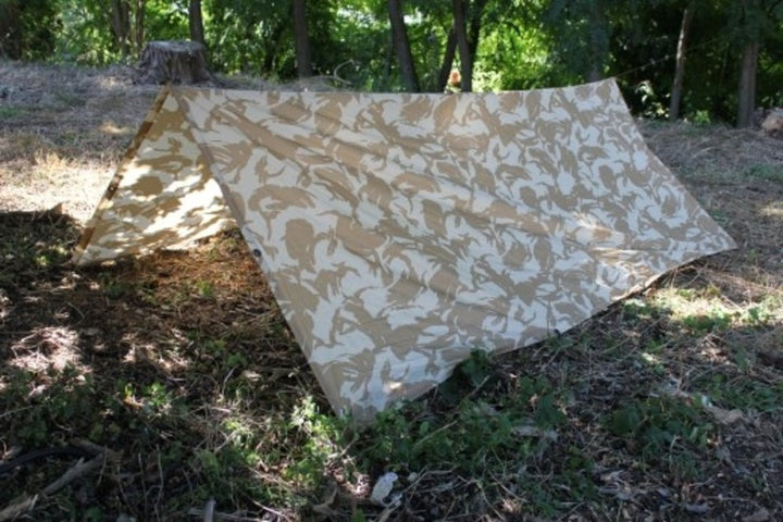 light colour camouflage basha shelter hung up from two trees