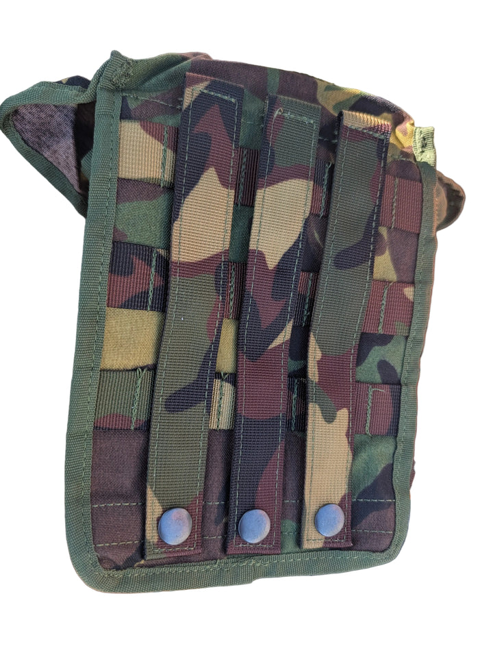 Camouflage pouch with multiple straps on a textured surface