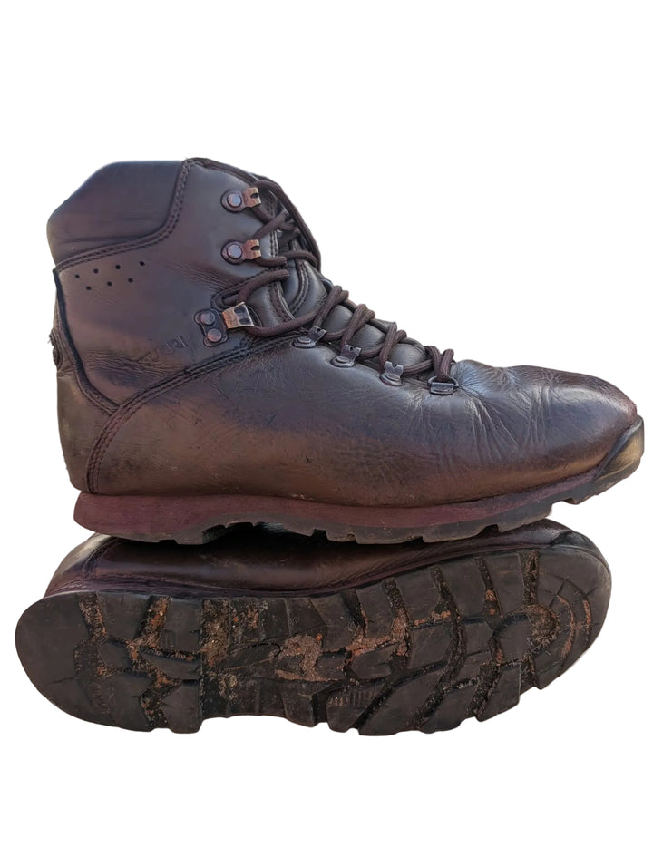 A dark brown leather lace-up boot with a rugged sole, shown resting on top of another boot&