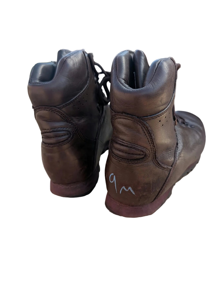 A pair of dark brown leather ankle boots with a handwritten &