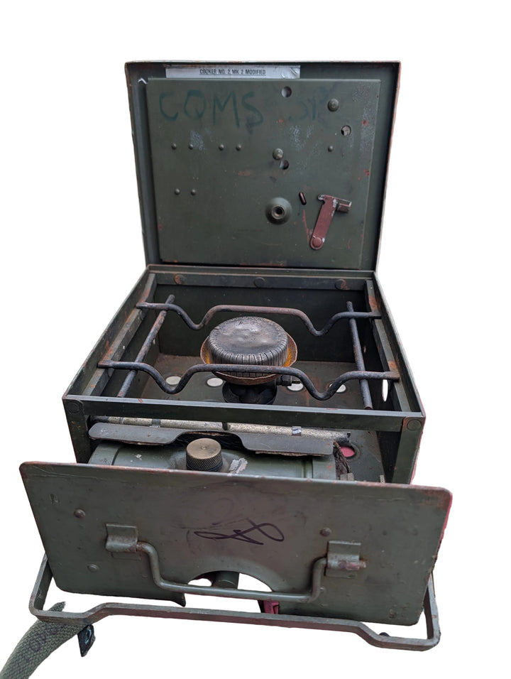 Portable gas stove with visible branding on a red surface