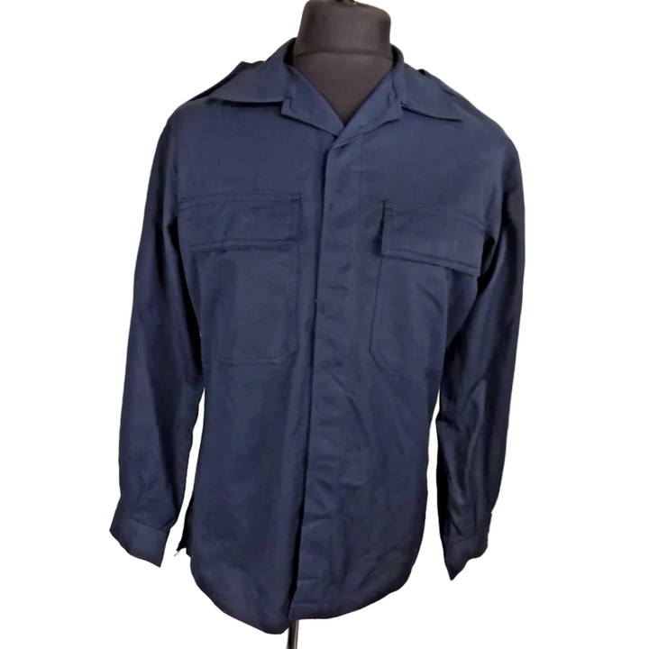 Navy blue jacket on a mannequin against a light stone wall background