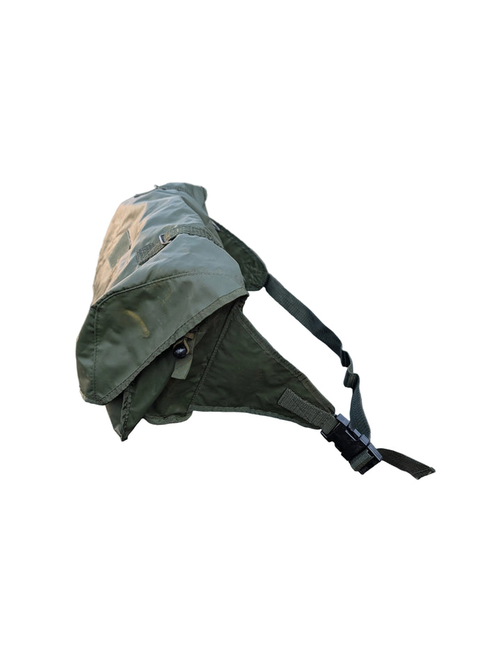 Green bag on a vehicle with a military-style background